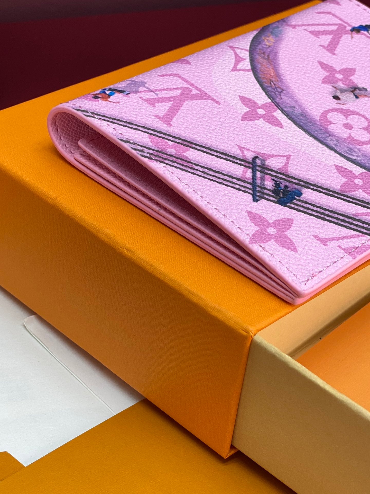 Pink patterned small bag wallet with fold-over design and stitched details