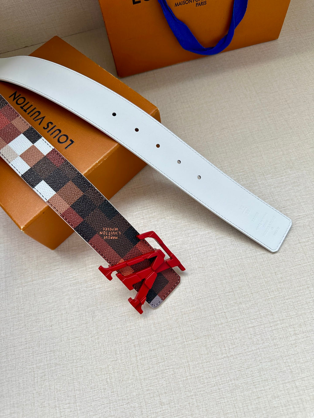 Louis Vuitton belt strap in white with checkered panel and red V buckle
