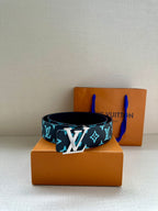 Louis Vuitton belt with navy strap and turquoise monogram pattern, centered oversized buckle