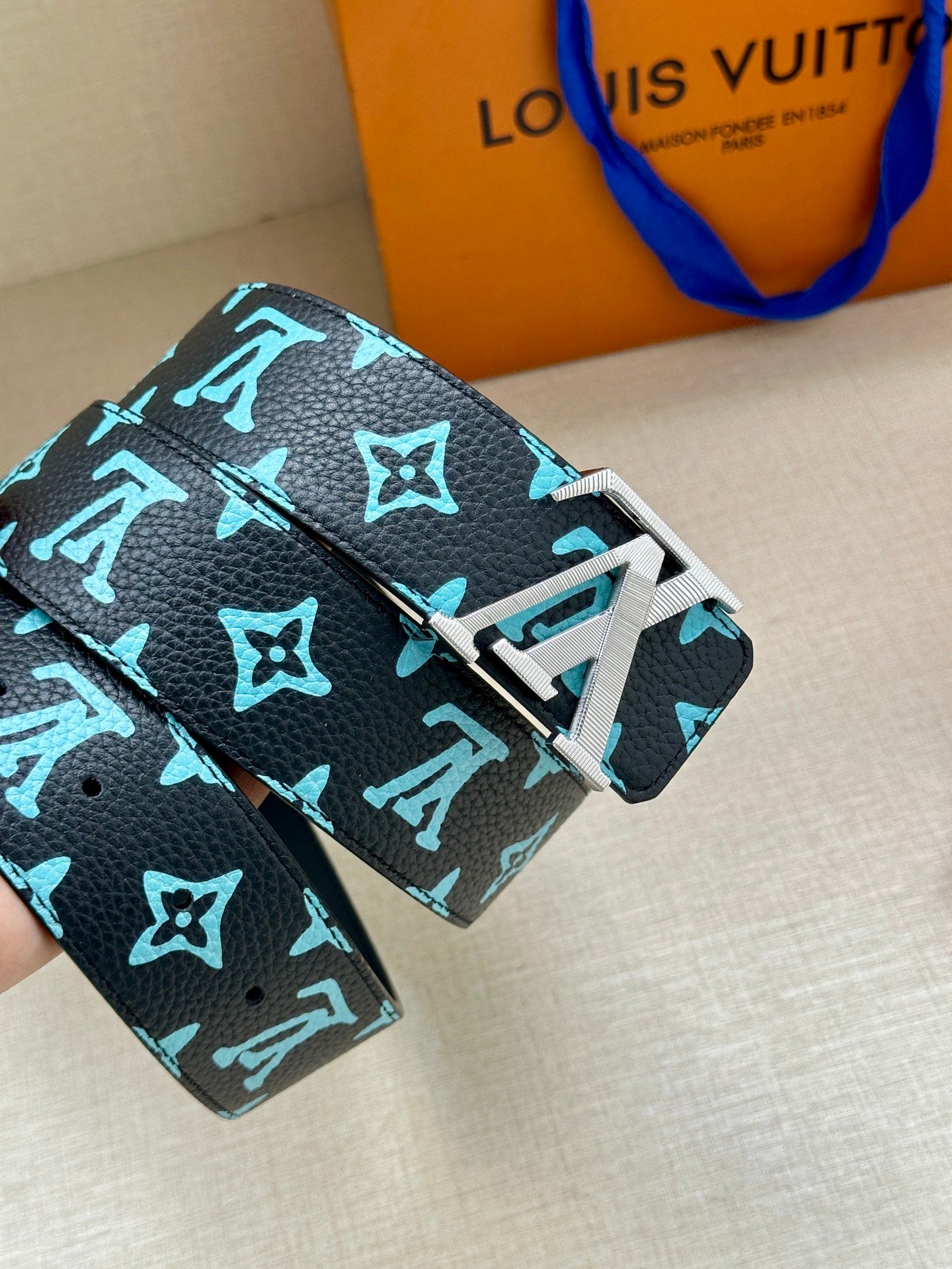 Louis Vuitton belt with dark navy textured strap and turquoise monogram, silver-toned buckle