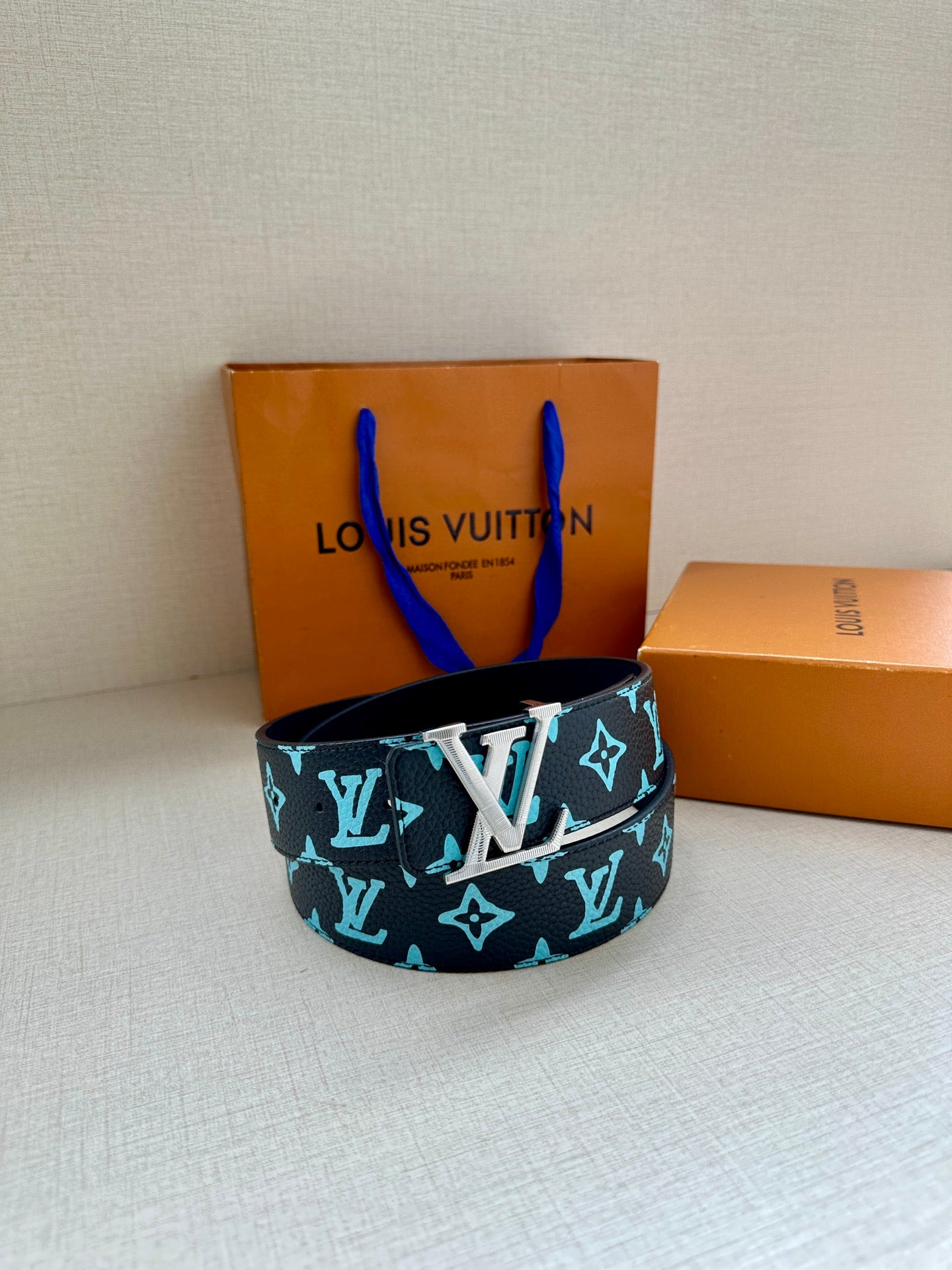 Louis Vuitton belt in a loop with dark navy strap and turquoise monogram pattern