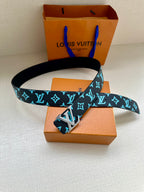 Louis Vuitton belt with dark navy and turquoise monogram strap and gold buckle clasp