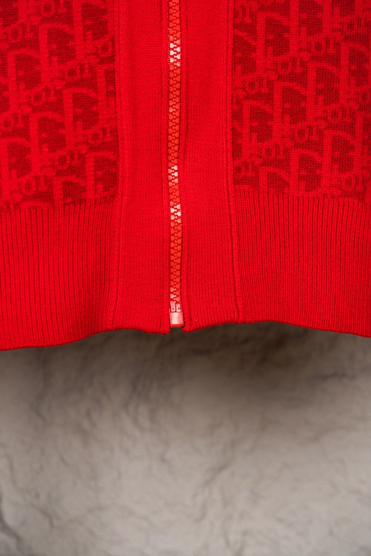 Red knit zip hoodie front with zipper and ribbed trim at hem