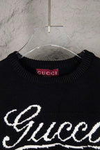 Black knit sweater neckline with Gucci logo label