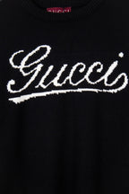 Black knit sweater with large white Gucci script graphic