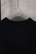 Black sweater neckline with ribbed collar on hanger