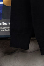 Black knit sweater sleeve with ribbed cuff