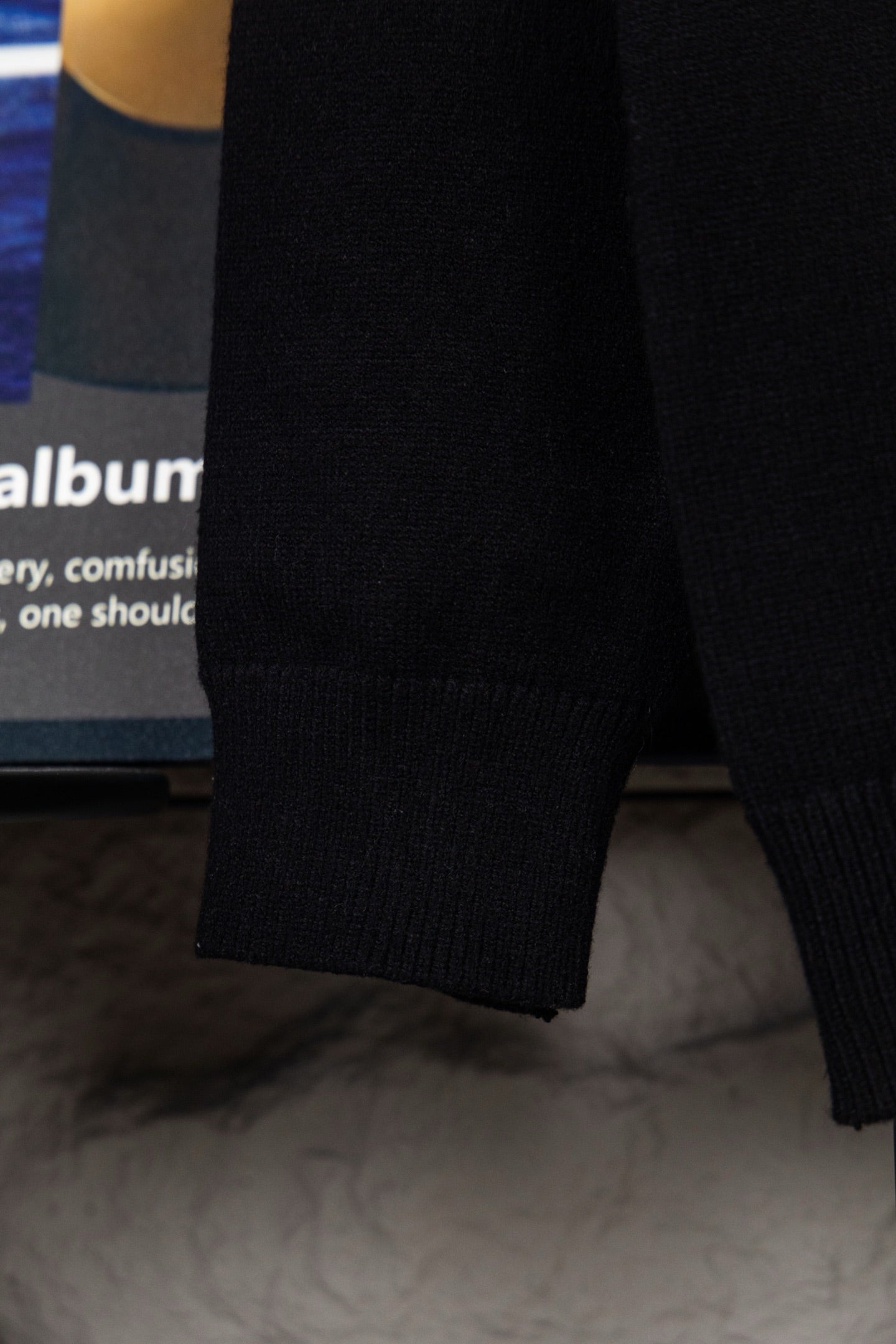 Black knit sweater sleeve with ribbed cuff