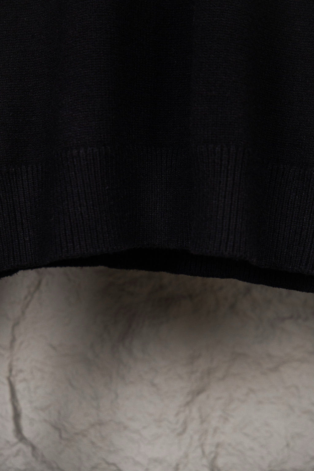 Black knit sweater hem with ribbed trim
