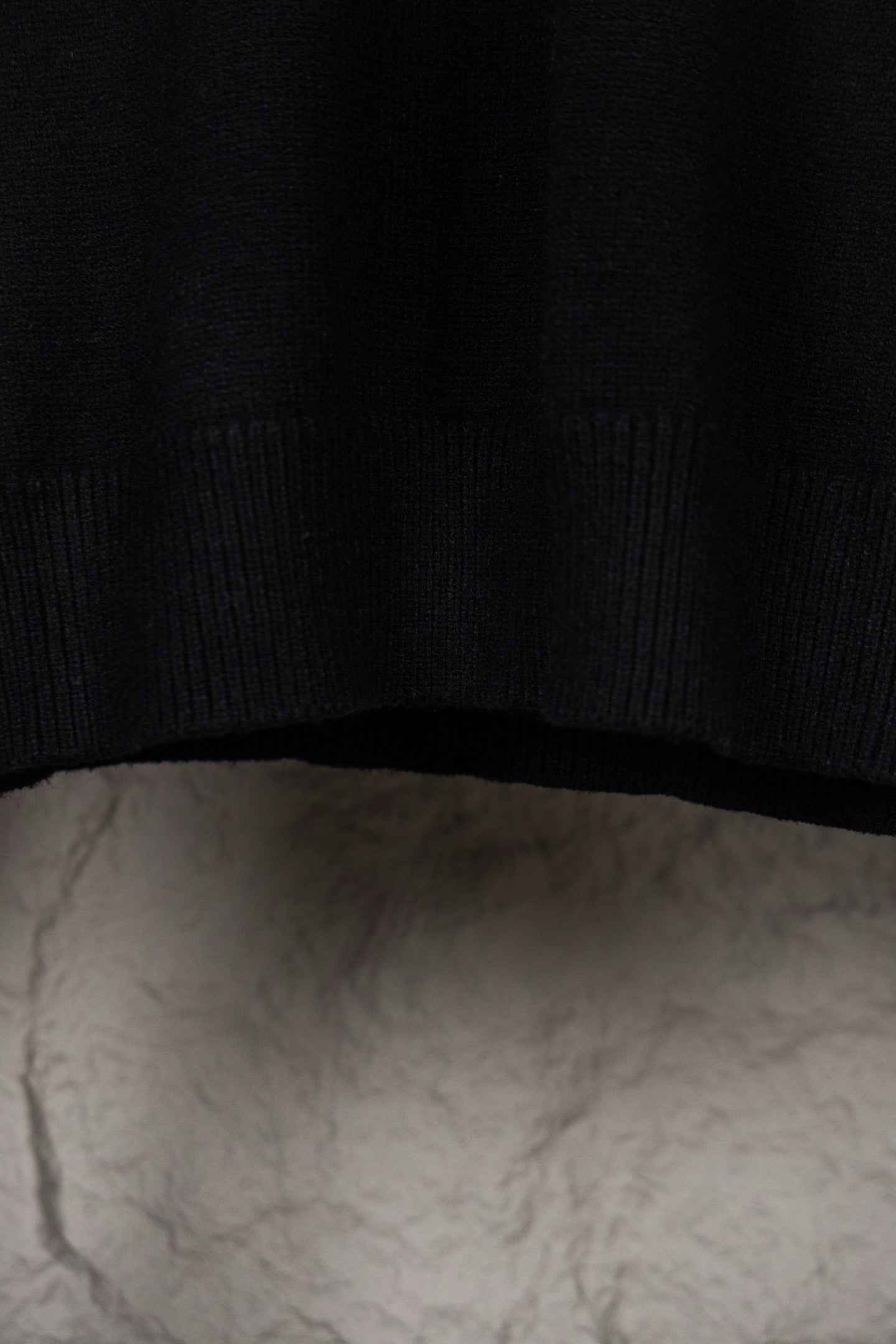 Black knit sweater hem with ribbed trim