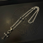 Silver cross pendant necklace with curb chain on embossed black box
