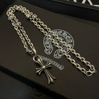 Silver cross pendant necklace with curb chain on black gift box