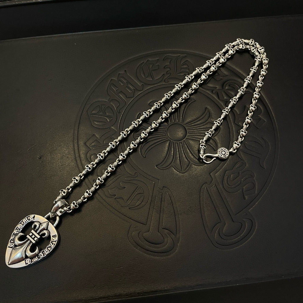 Heart pendant necklace with silver-tone chain and heart charm on embossed black box