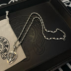 Heart pendant necklace with silver-tone links and heart charm on black box