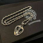 Heart pendant necklace with silver-tone chain and heart charm on black box