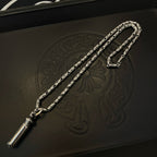 Silver-toned charm necklace with cylinder pendant, shown on a dark leather box