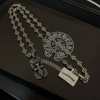 Silver beaded chain necklace with pendant charms and rectangular tag on case