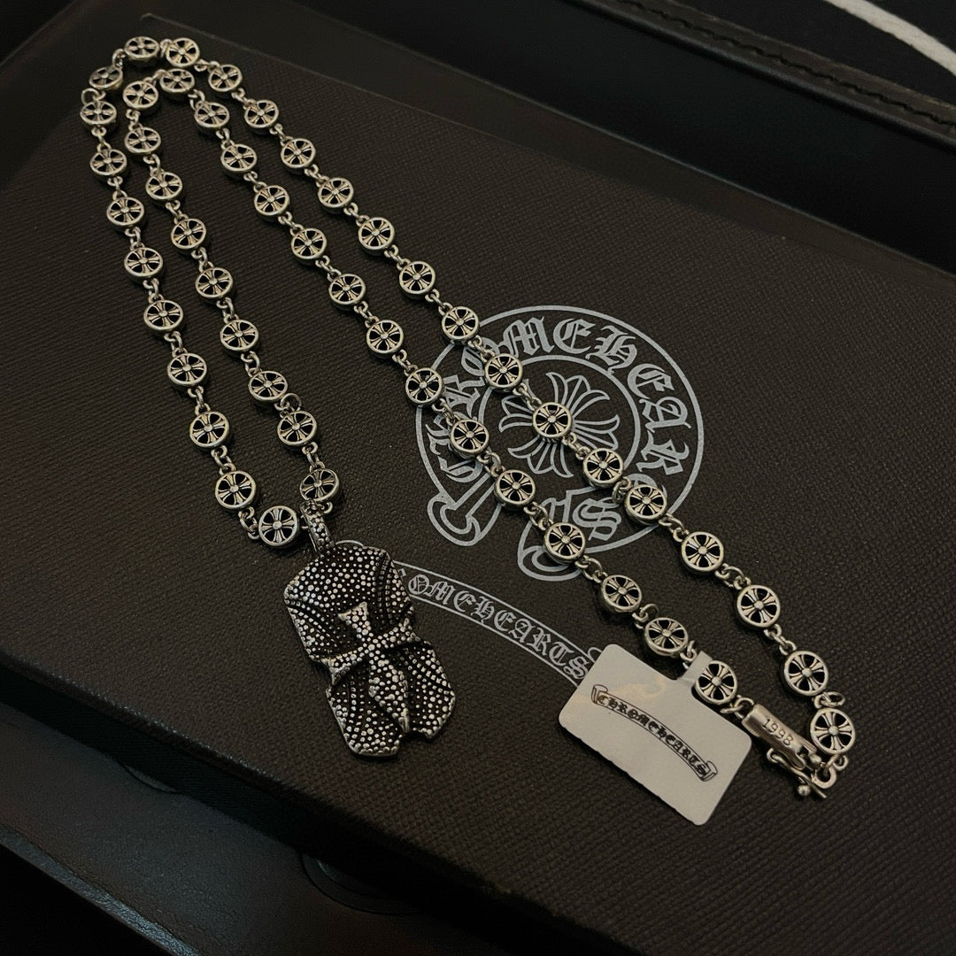 Silver beaded chain necklace with pendant charms and rectangular tag on case