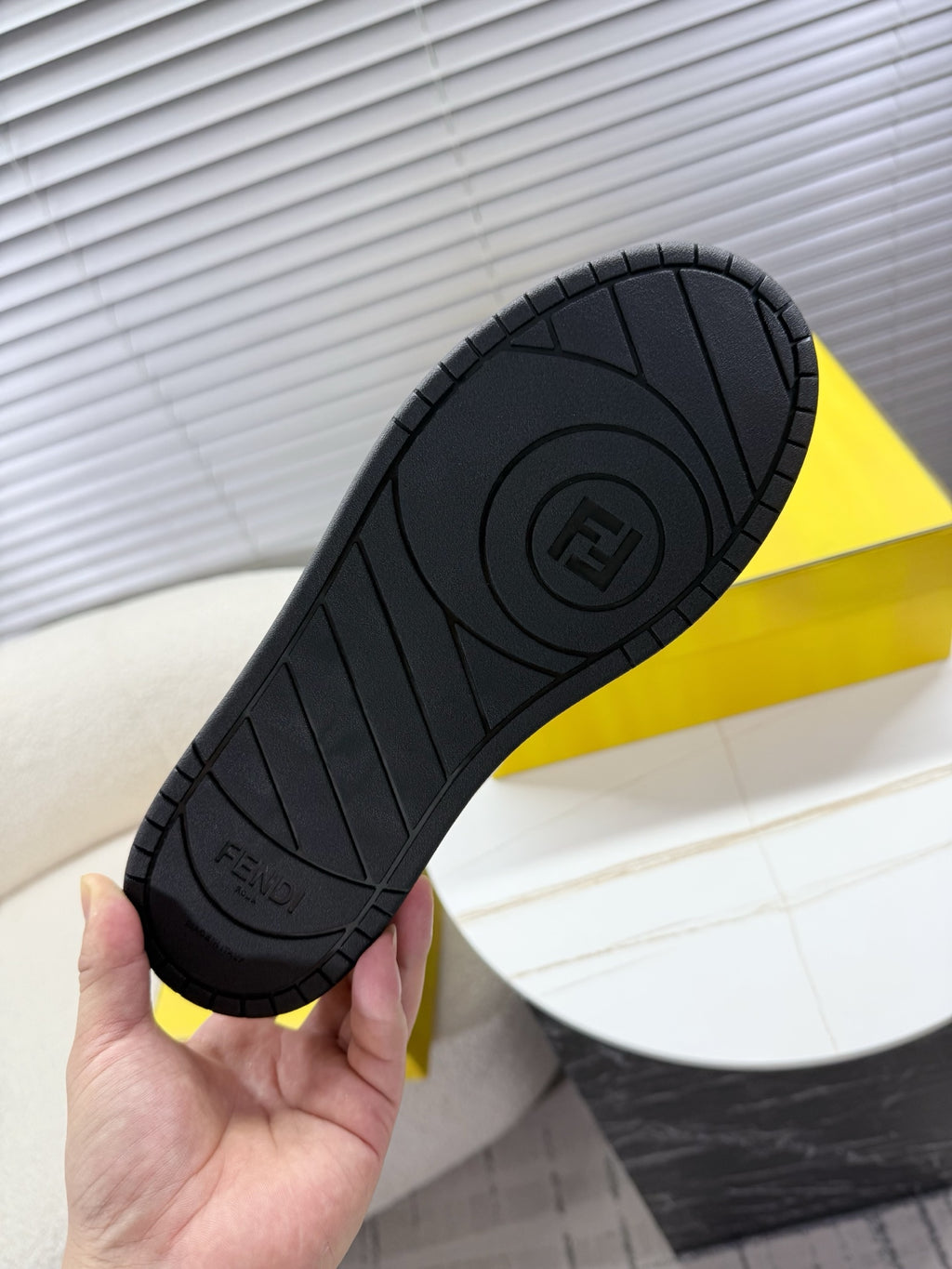 Black rubber sneaker outsole with tread pattern and FENDI mark