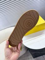 Fendi unisex sneaker outsole view, brown tread with Fendi logo center.