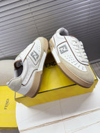 Fendi unisex sneakers with white leather-look uppers and tan rubber soles.