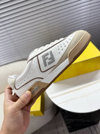 Fendi unisex sneaker side view with FF logo patch, white with tan trim.