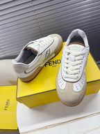 Fendi unisex sneakers pair with white uppers, beige lining, and lace-up design.