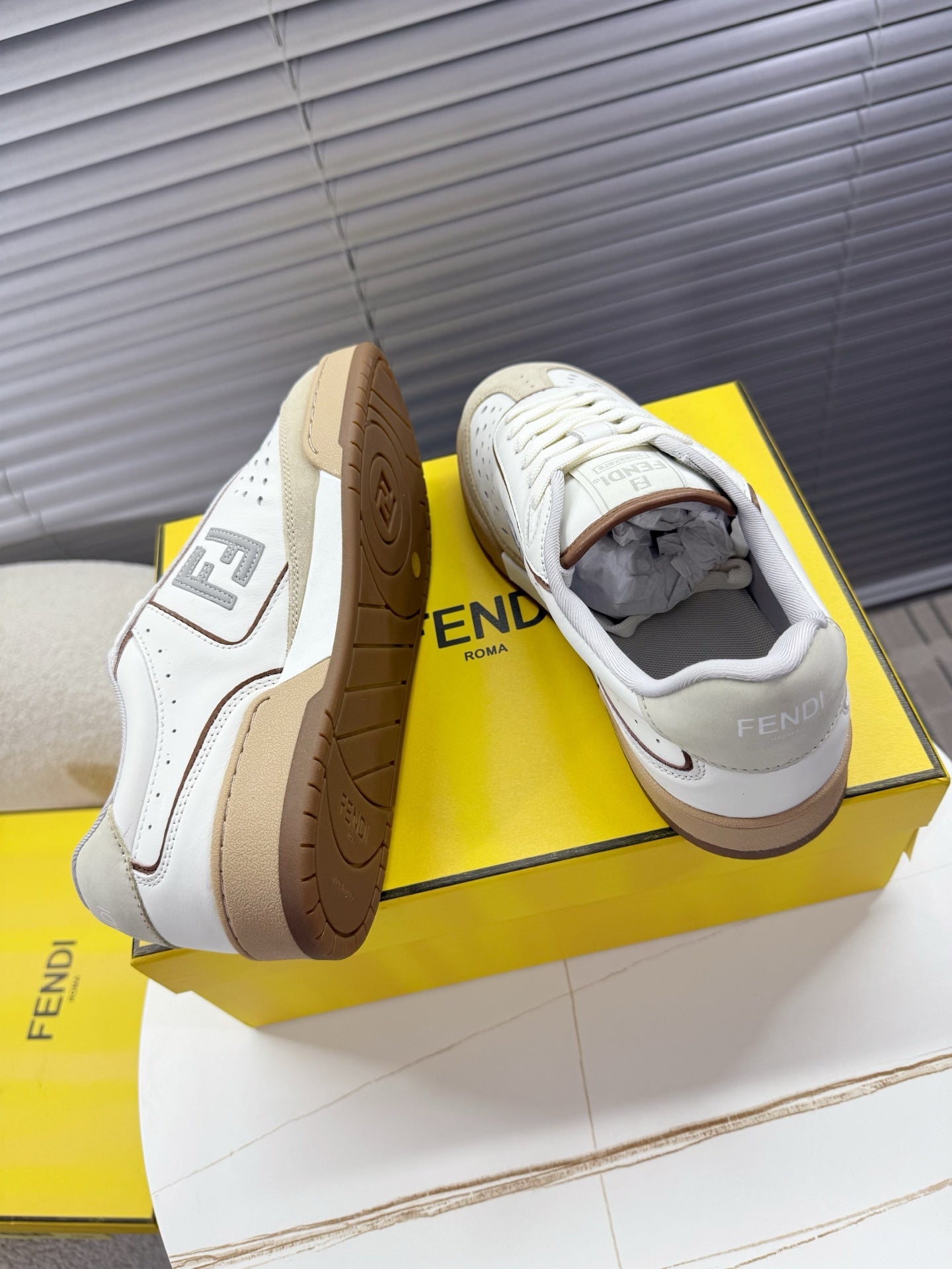 Fendi unisex sneakers showing tan rubber outsoles and open collar, lace-up.