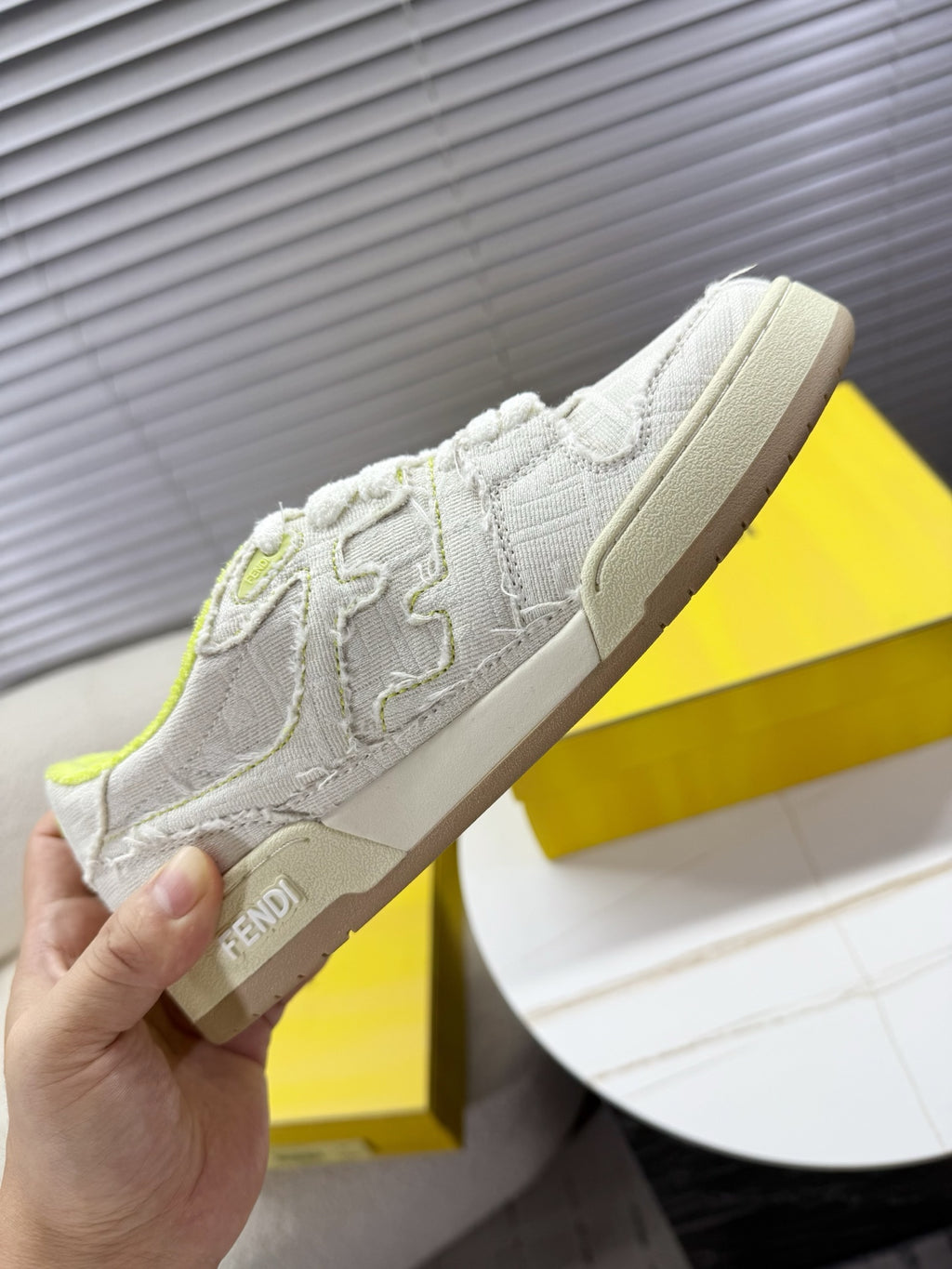 Fendi unisex sneakers: white low-top with neon green collar, beige outsole, side logo detail