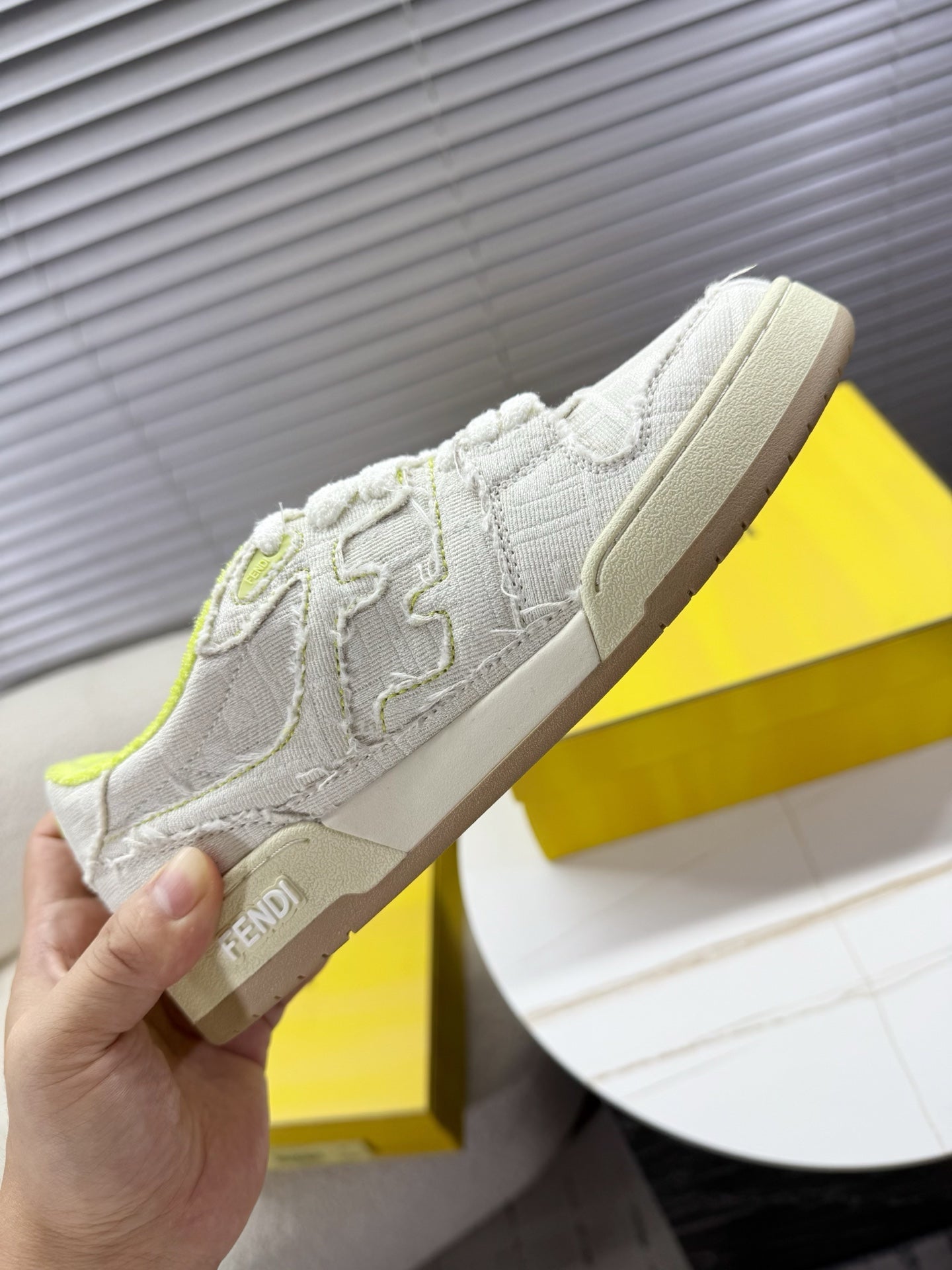 Fendi unisex sneakers: white low-top with neon green collar, beige outsole, side logo detail