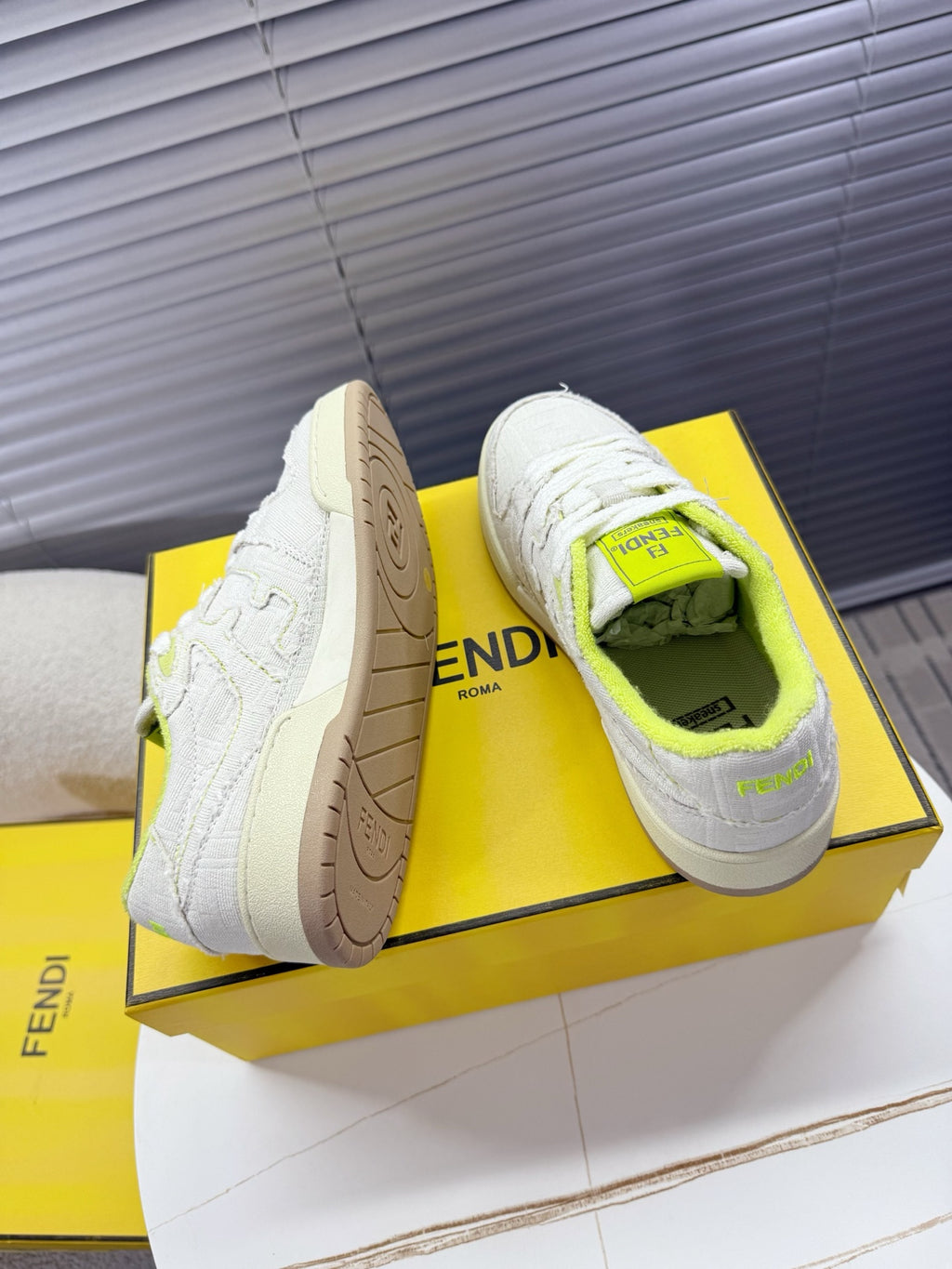 Fendi unisex sneakers: white low-top with neon green interior, textured sides, beige outsole