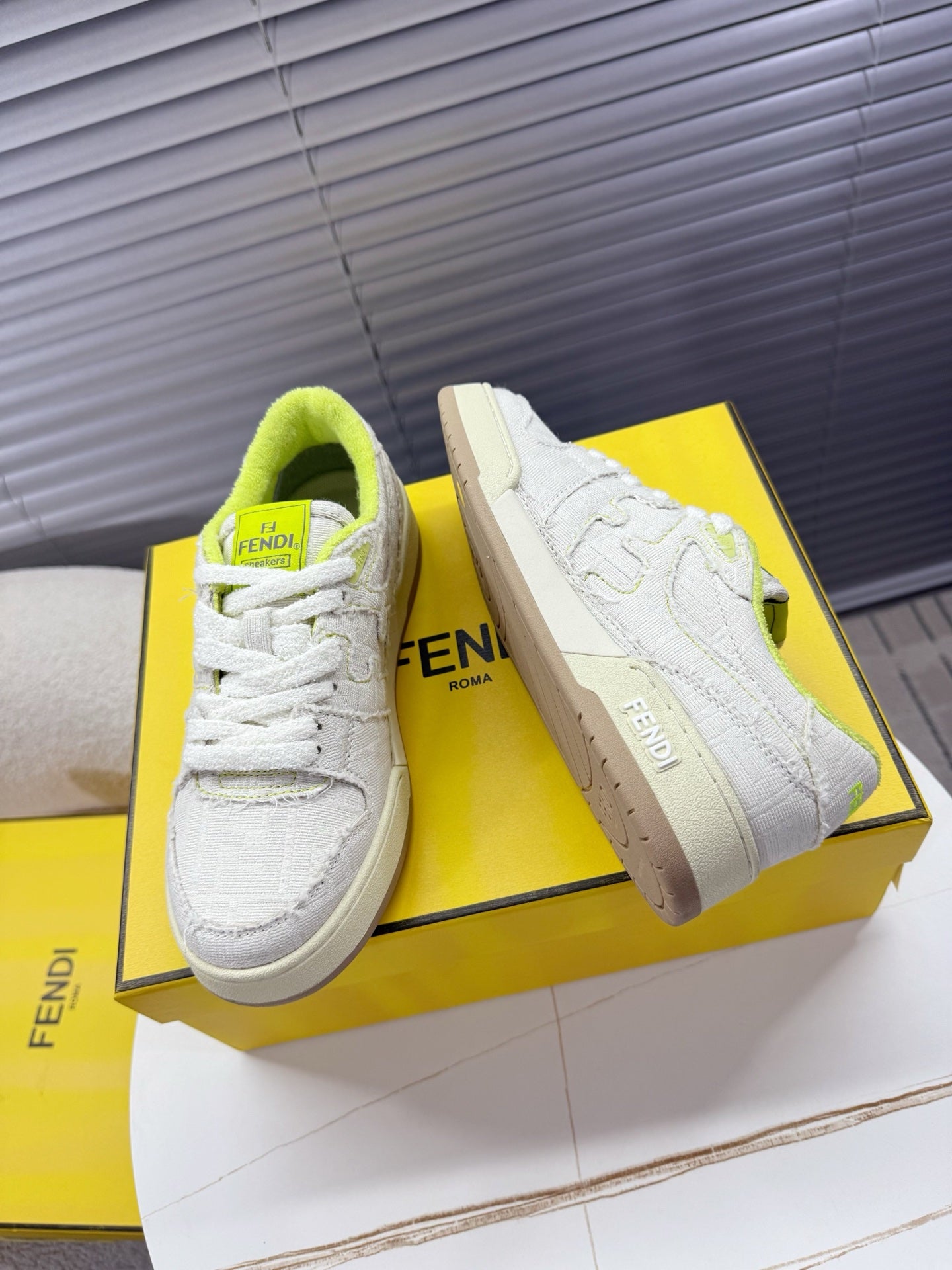 Fendi unisex sneakers: white low-top lace-up with neon green lining and Fendi Roma side logo