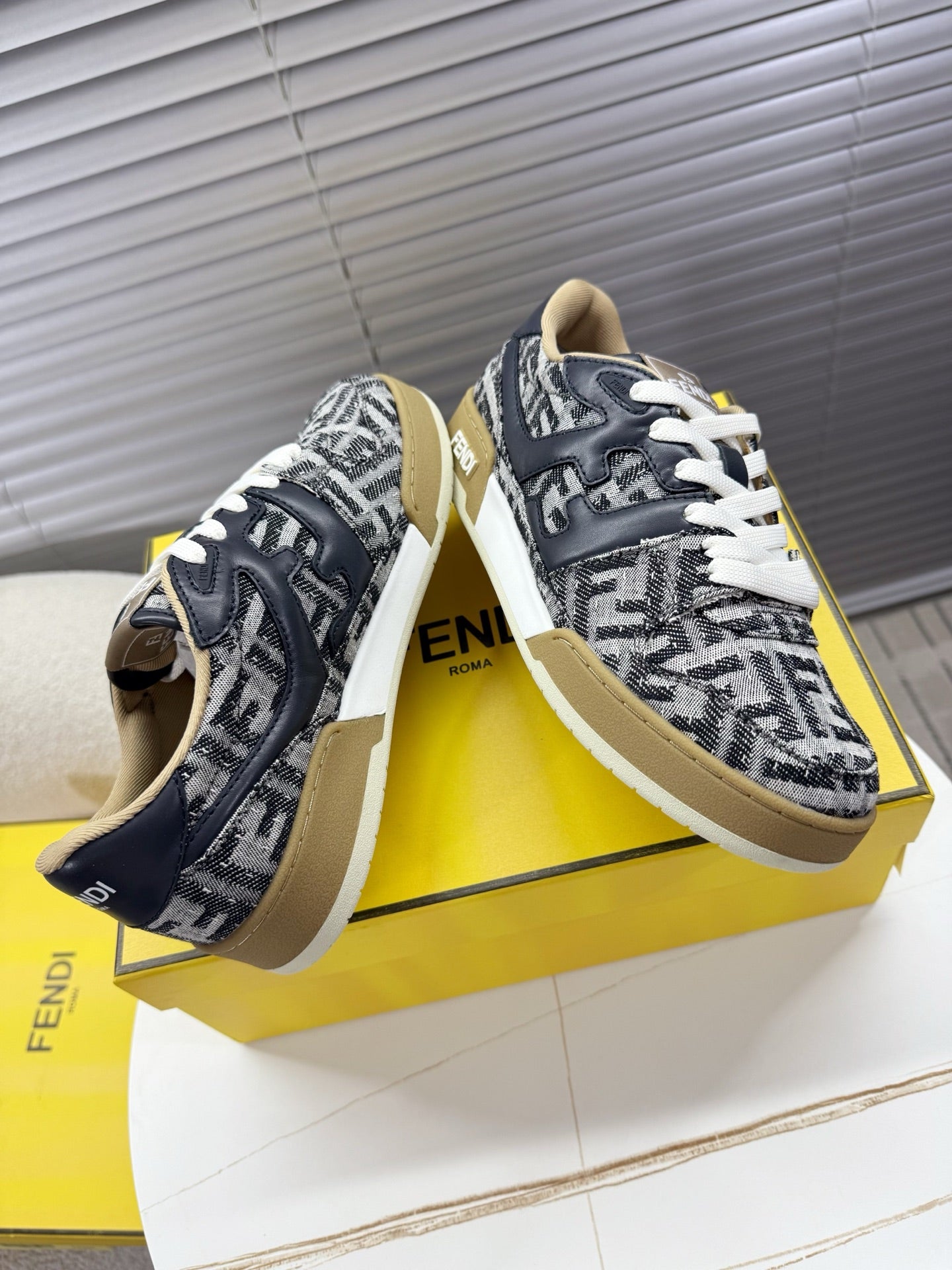 Fendi unisex sneakers top and side view, navy and white FF print, white lace-up