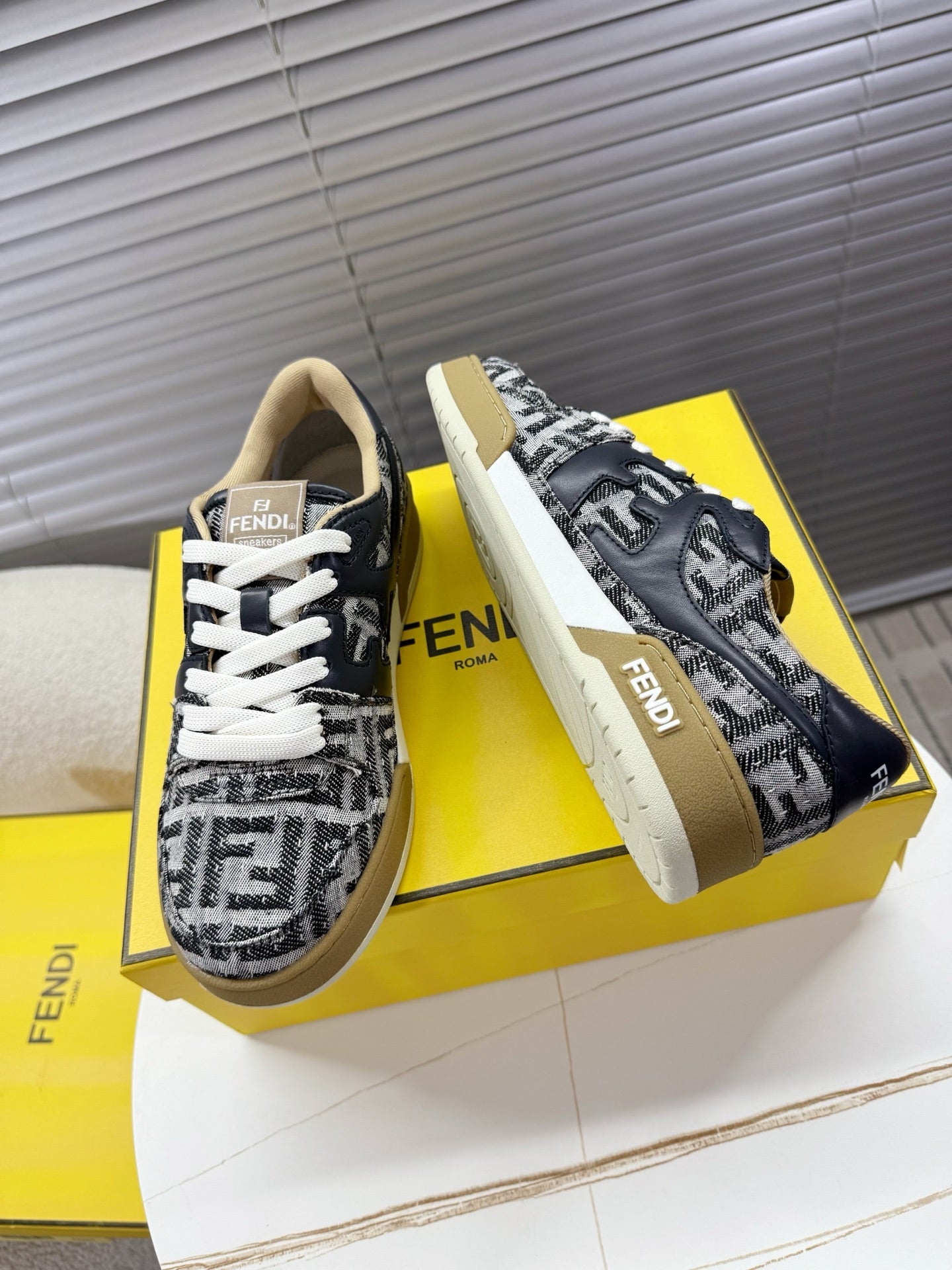 Fendi unisex sneakers angled side view, navy and white FF print, thick rubber sole