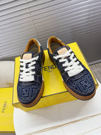 Navy Fendi sneakers with FF monogram, white laces, tan trim and rubber sole.