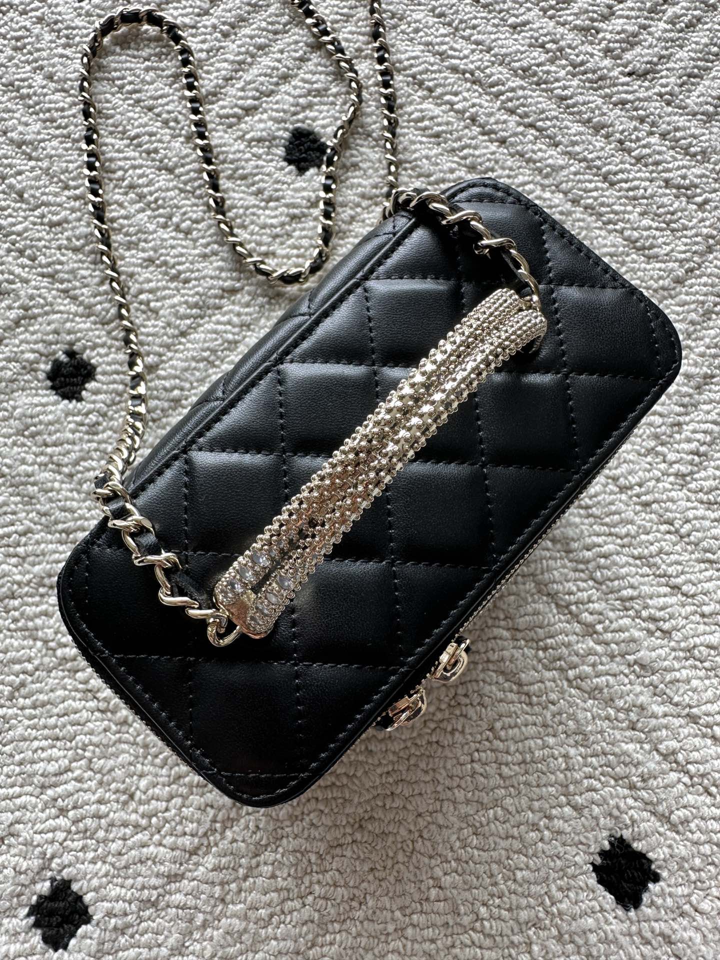 Chanel quilted mini bag with chain strap and clasp, black leather look