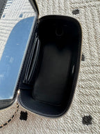 Chanel bag open view showing dark interior phone compartment, zipper trim