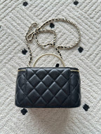 Chanel quilted bag with chain shoulder strap, black stitched diamond pattern