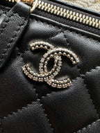 Chanel bag zipper top with rhinestone CC charm, black leather texture