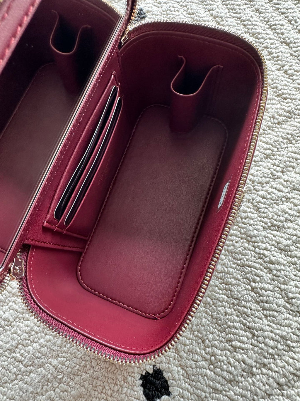 Chanel quilted mini bag interior view, burgundy lining with card compartments