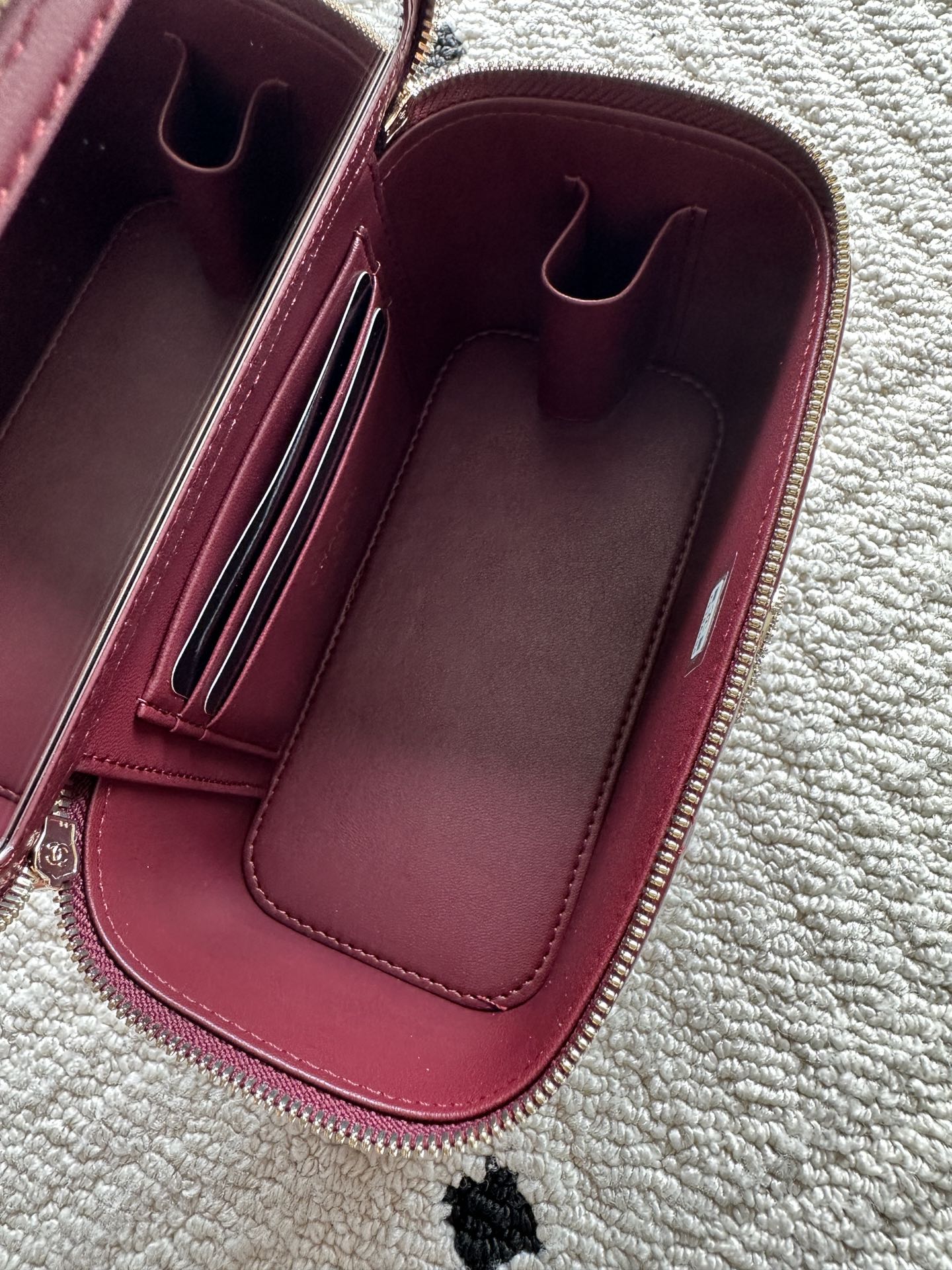 Chanel quilted mini bag interior view, burgundy lining with card compartments