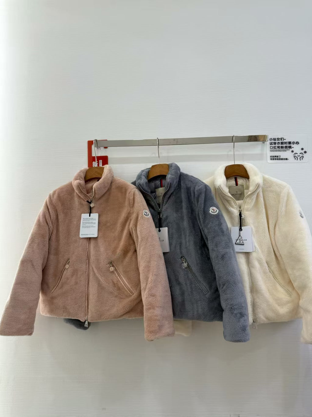 Long-sleeve zip fleece jacket with hood, taupe, on a hanger
