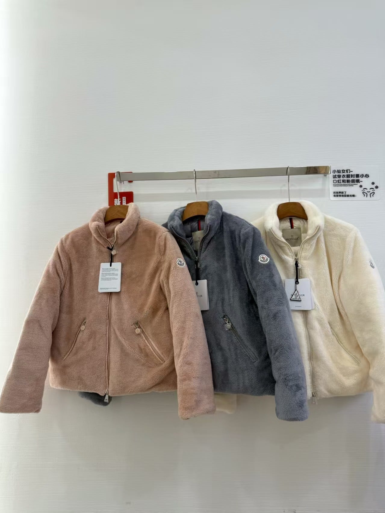 Long-sleeve zip fleece jacket with hood, taupe, on a hanger