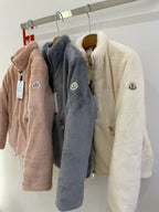 Long-sleeve zip fleece jackets with hood in tan, charcoal, and cream on hangers