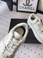 White leather sneakers, close-up of heel collar and lace-up eyelets