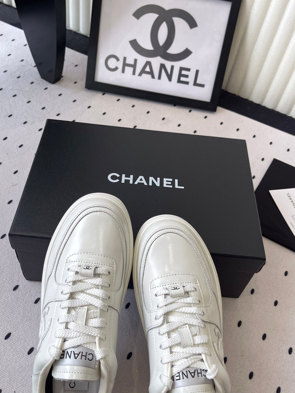 White leather lace-up sneakers with Chanel logo on tongue and front