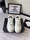 White leather low-top sneaker with lace-up front and Chanel logo detail