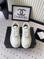White leather lace-up sneakers with Chanel CC logo, low-top style