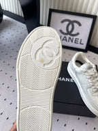 White rubber sneaker outsole with Chanel CC logo and tread pattern