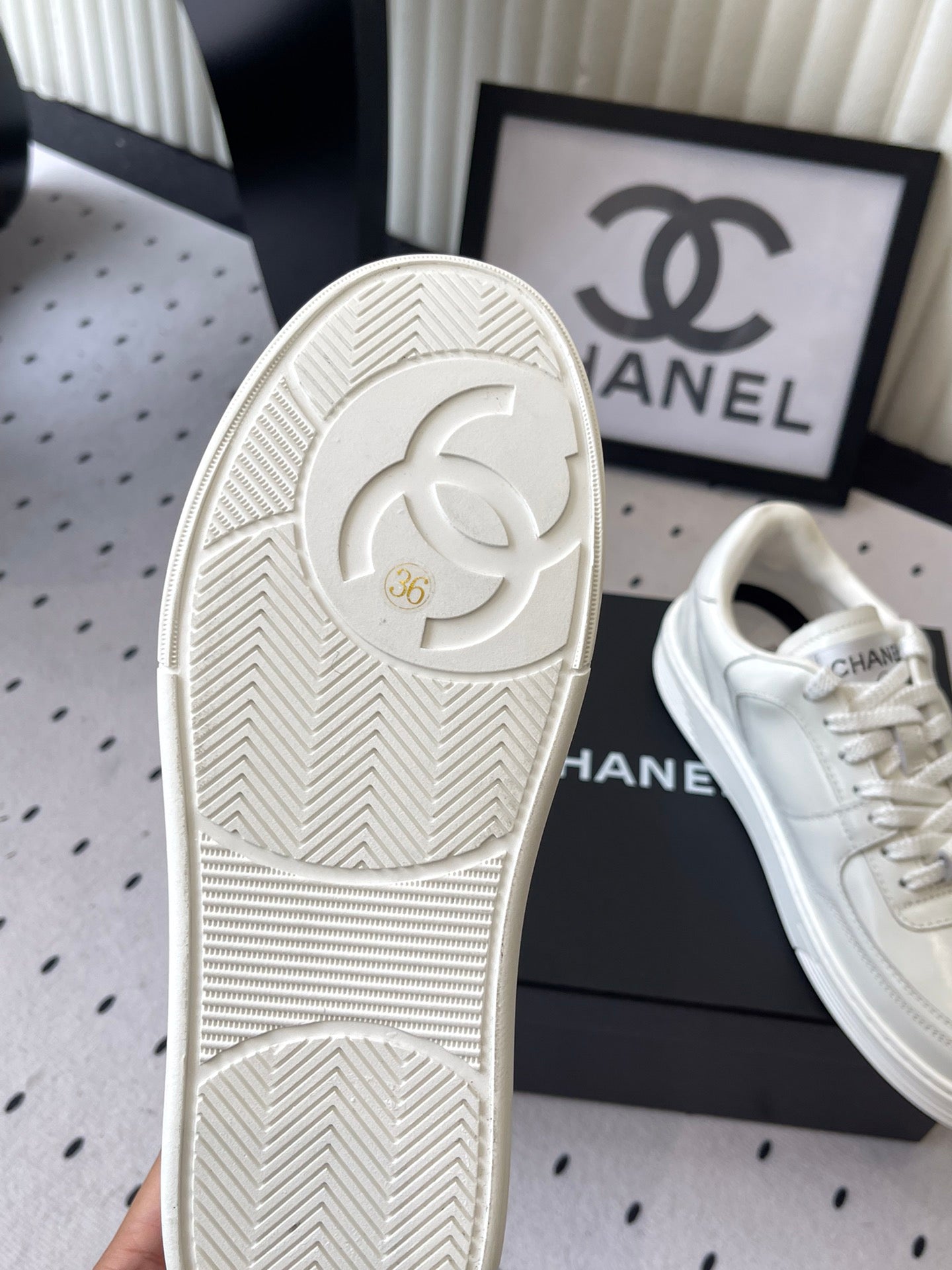 White rubber sneaker outsole with Chanel CC logo and tread pattern